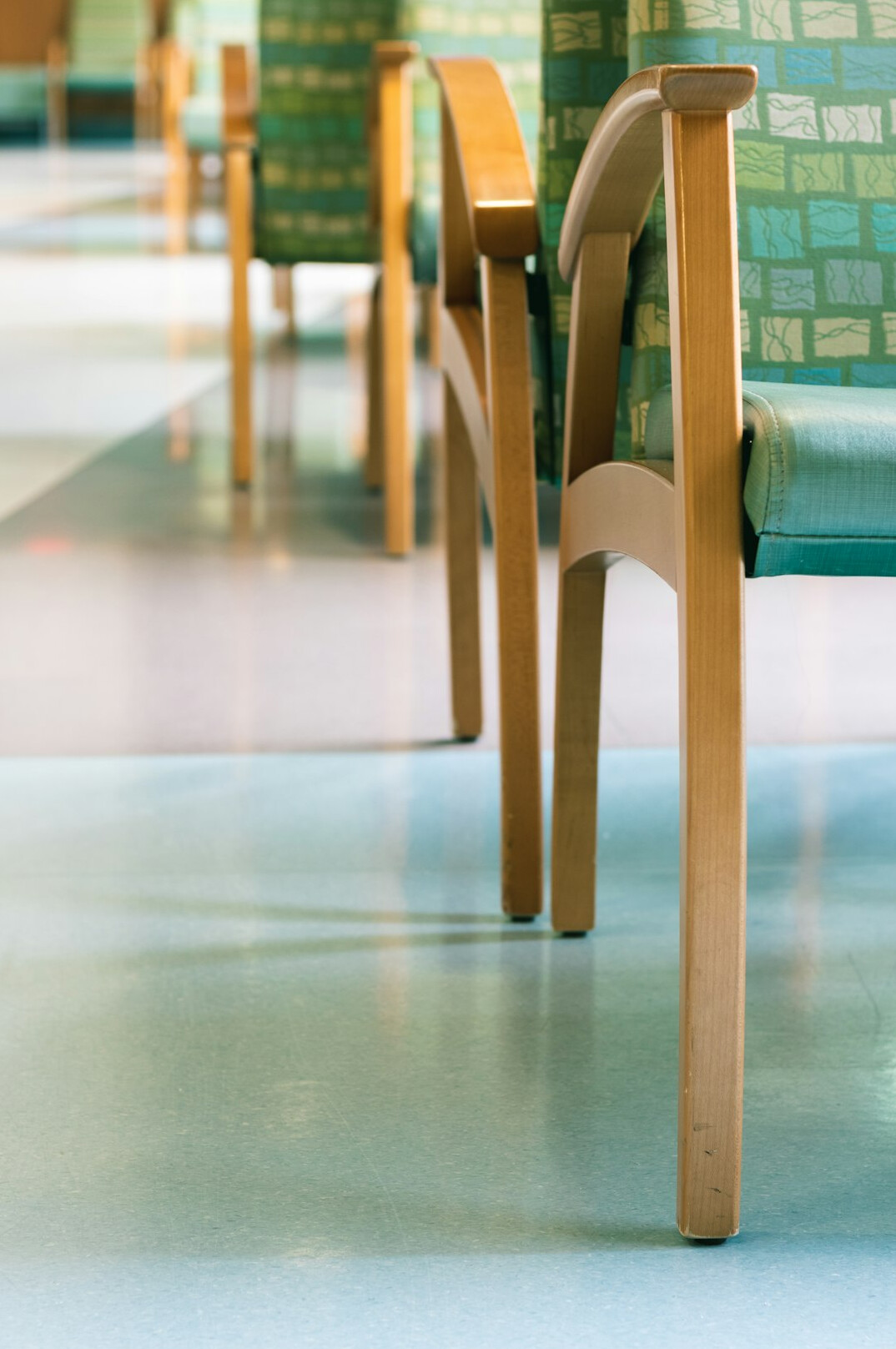 Empty hospital waiting room with rows of chairs